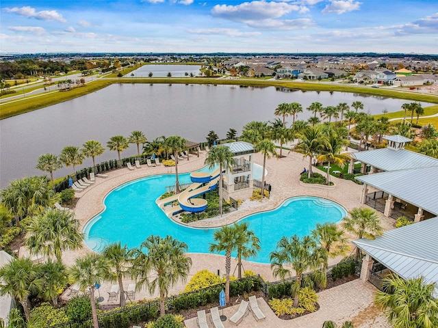 view of pool with a water slide, a gazebo, a patio area, and a water view