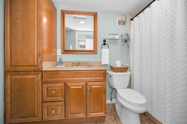 bathroom with tile patterned floors, vanity, and toilet