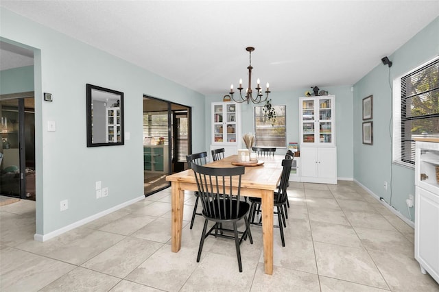 tiled dining room featuring a chandelier and a textured ceiling