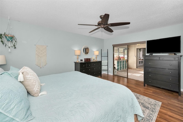 bedroom featuring a textured ceiling, ceiling fan, and dark hardwood / wood-style floors