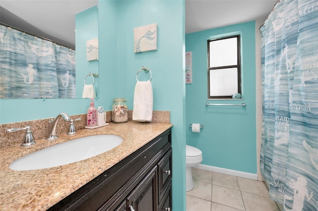 bathroom with toilet, vanity, and tile patterned floors