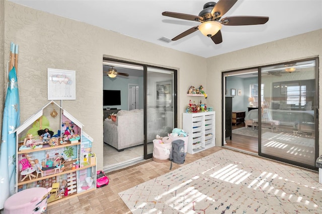 interior space with ceiling fan and a closet