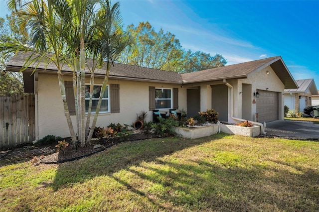 single story home featuring a garage and a front lawn