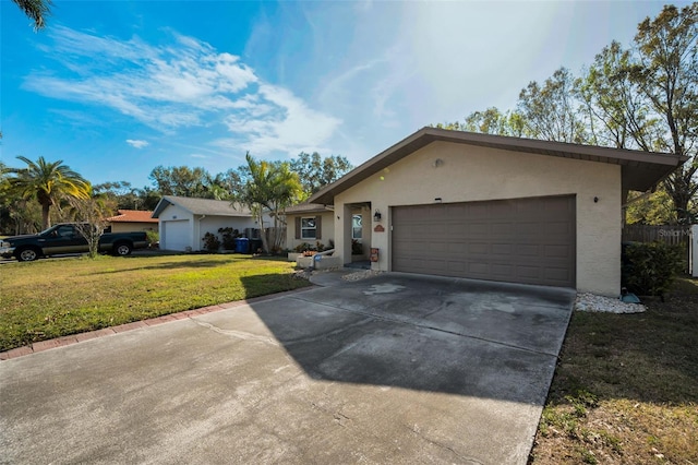 ranch-style house featuring a garage and a front lawn