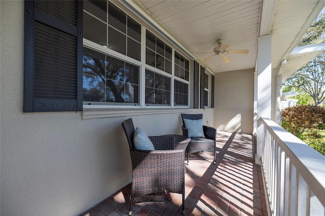 balcony featuring a porch and ceiling fan