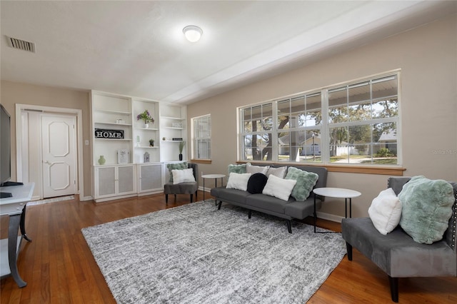 sitting room featuring wood finished floors, visible vents, and baseboards