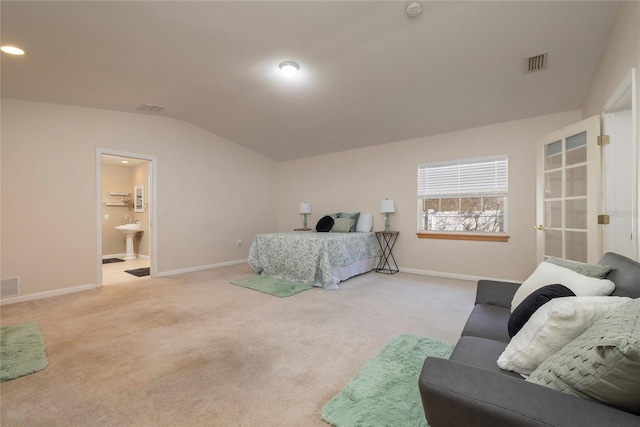 bedroom with visible vents, vaulted ceiling, light carpet, and baseboards