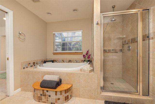 bathroom with a garden tub, tile patterned flooring, and a shower stall