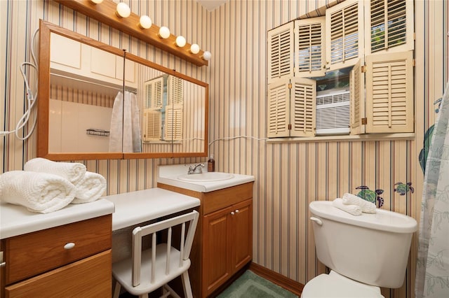 bathroom featuring vanity, toilet, and wallpapered walls