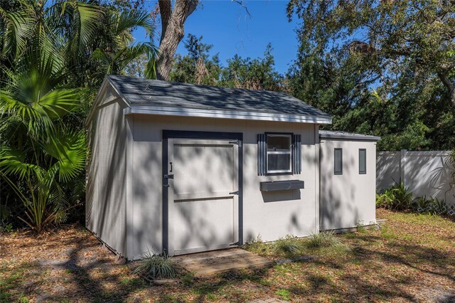 view of shed featuring fence