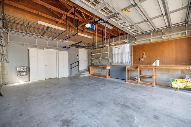 garage featuring a garage door opener and a workshop area