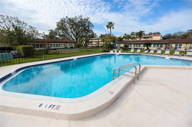 view of swimming pool featuring a yard and a patio