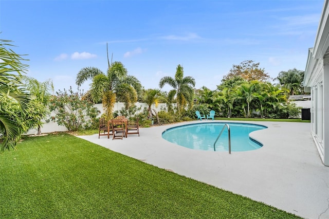 view of pool featuring a yard and a patio area