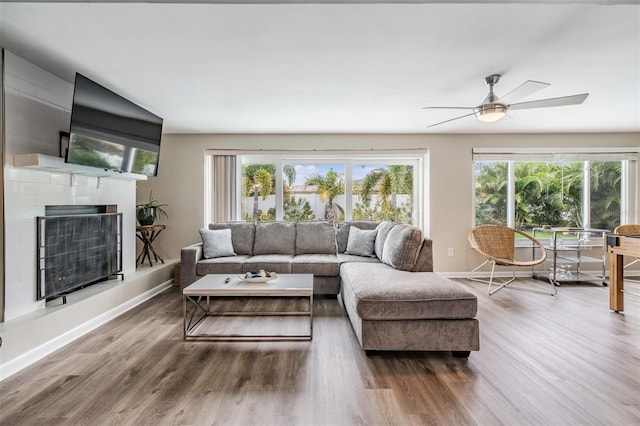 living room with hardwood / wood-style floors, plenty of natural light, and ceiling fan