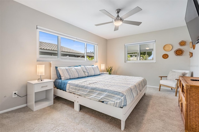 bedroom with ceiling fan and light colored carpet