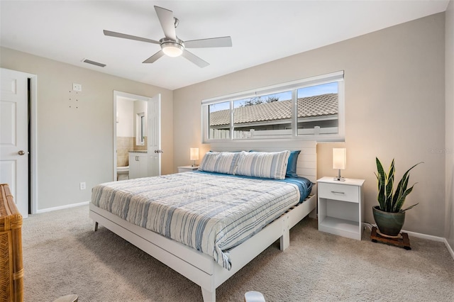 carpeted bedroom featuring ensuite bathroom and ceiling fan