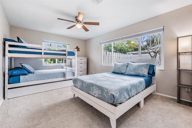 bedroom featuring carpet flooring, multiple windows, and ceiling fan