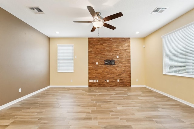 unfurnished living room featuring ceiling fan and light hardwood / wood-style flooring