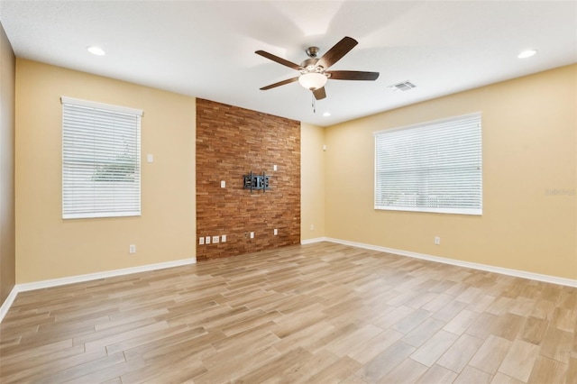 unfurnished living room with ceiling fan and light wood-type flooring