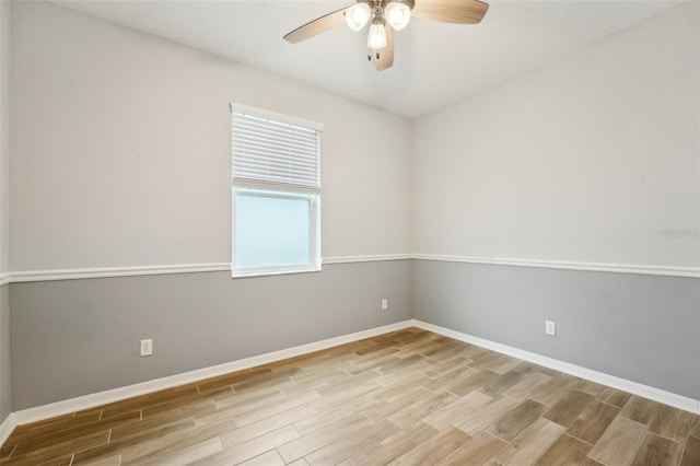 spare room with plenty of natural light, ceiling fan, and light hardwood / wood-style flooring