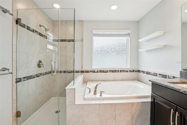 bathroom featuring vanity and plus walk in shower