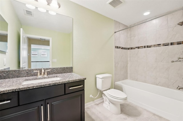 full bathroom featuring tile patterned floors, vanity, toilet, and tiled shower / bath