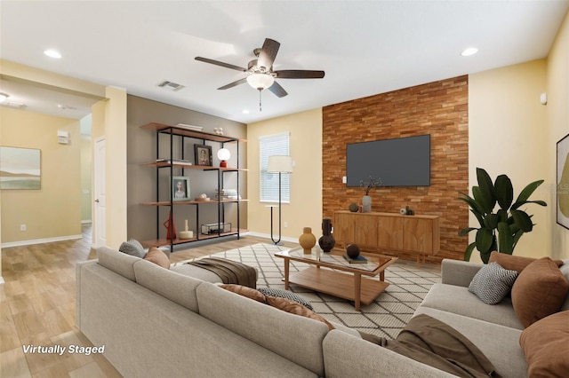 living room featuring light hardwood / wood-style floors and ceiling fan