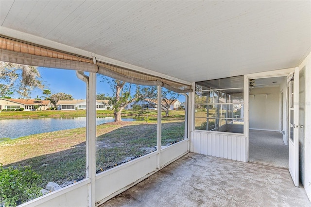 unfurnished sunroom with a water view