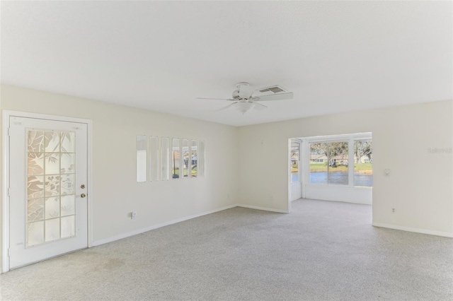 carpeted empty room featuring ceiling fan