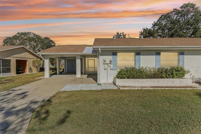 view of front of home with a yard and a carport