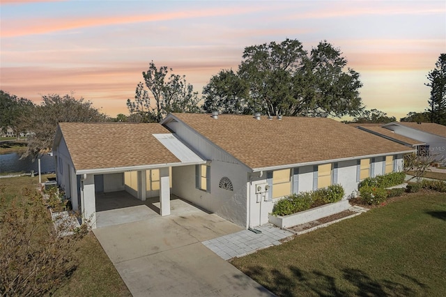 ranch-style house with a carport and a yard