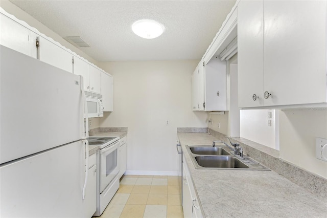 kitchen featuring sink, light tile patterned floors, a textured ceiling, white appliances, and white cabinets