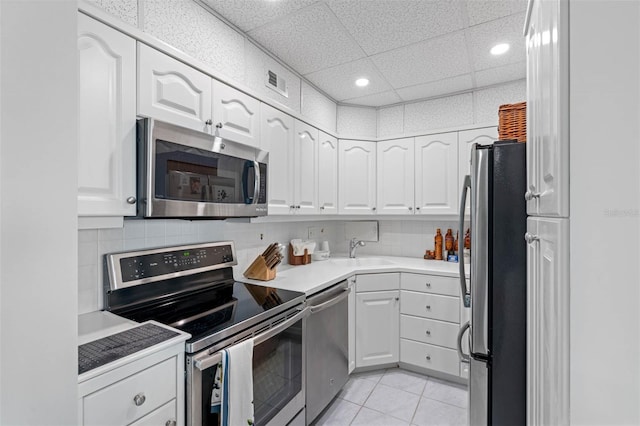 kitchen featuring a paneled ceiling, sink, white cabinetry, and stainless steel appliances