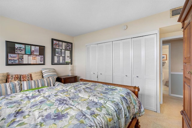 bedroom with light carpet and a closet