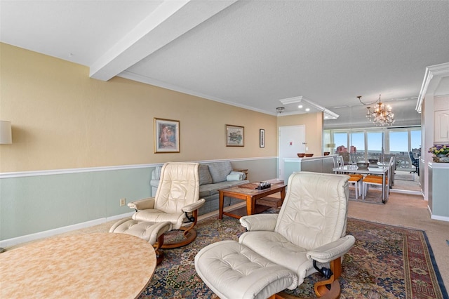 carpeted living room with beamed ceiling, ornamental molding, a textured ceiling, and a notable chandelier