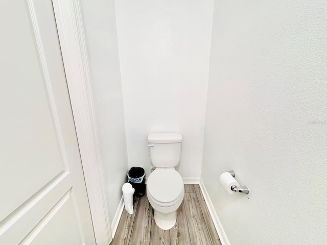 bathroom with hardwood / wood-style floors and toilet