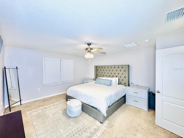 carpeted bedroom with a textured ceiling and ceiling fan