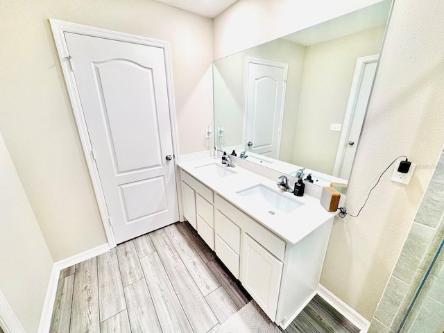 bathroom with hardwood / wood-style floors and vanity