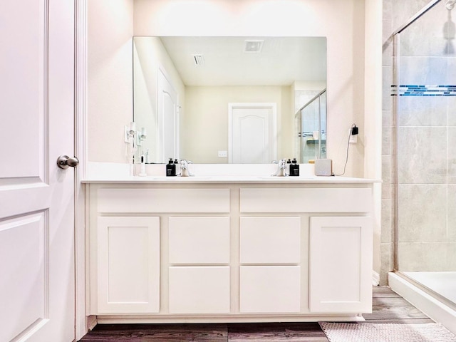 bathroom featuring a shower with door, vanity, and hardwood / wood-style flooring