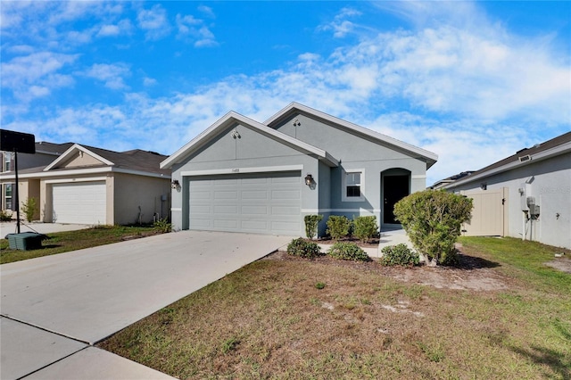 view of front of property with a garage and a front yard