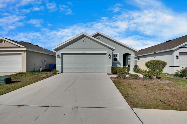 single story home with a garage and a front lawn