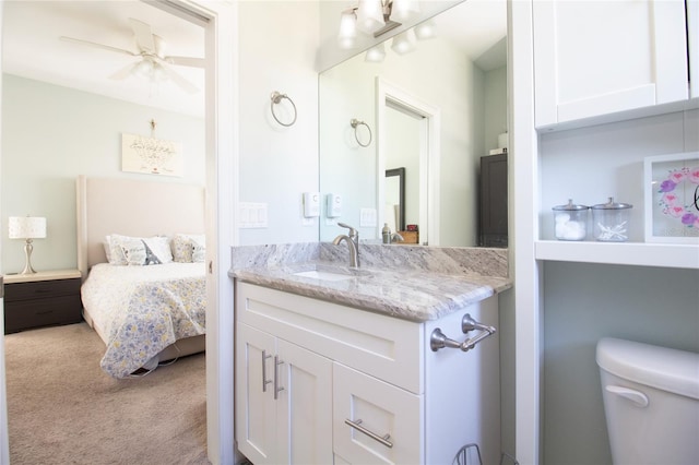 bathroom featuring ceiling fan, toilet, and vanity