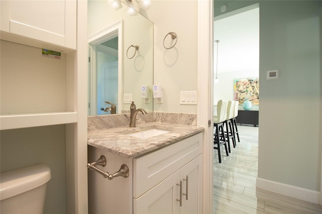 bathroom featuring vanity and toilet