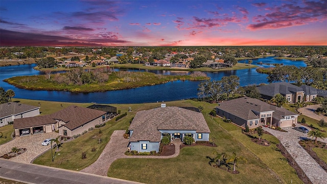 aerial view at dusk with a water view