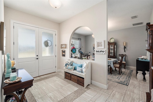 entryway featuring a textured ceiling and plenty of natural light