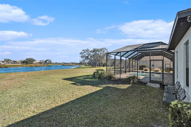 view of yard with a lanai and a water view