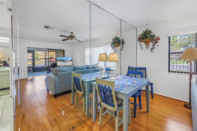 dining area with ceiling fan and hardwood / wood-style floors