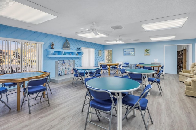 dining area with ceiling fan and light hardwood / wood-style floors