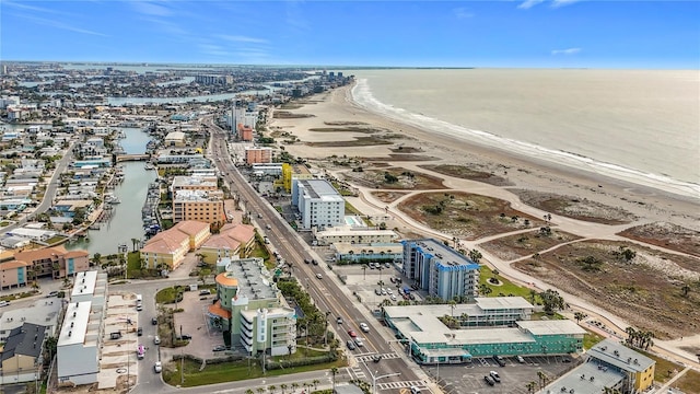 birds eye view of property with a water view and a view of the beach