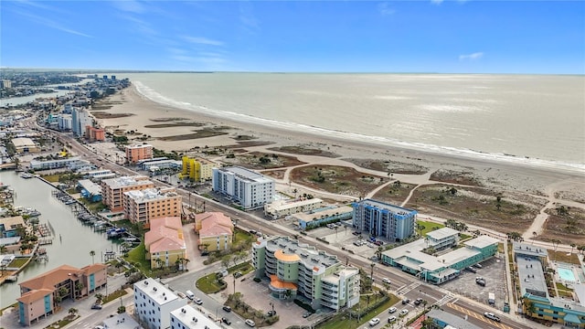 drone / aerial view with a water view and a view of the beach